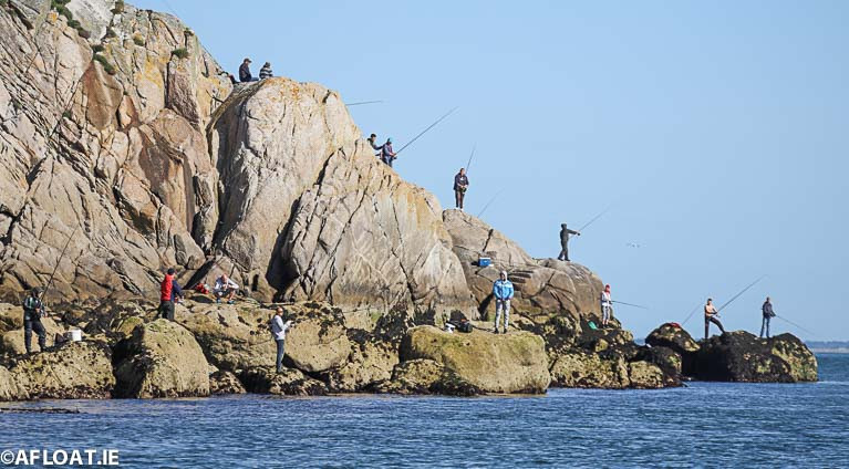Anglers perched on the rocks on the Dalkey coastline