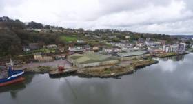 An 8-acre waterfront site up for sale at the former Royal Victoria Dockyard located in Passage West, Cork Harbour. The site is owned by Doyle Shipping Group (DSG). Afloat adds that the property includes a quay (see cargoship&#039;s bow) that extends eastward (not included in the photo) to the left.