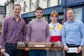 (From left) Regatta organiser Charles Dwyer (and fouth overall) with Darragh O&#039;Sullivan with the Yard of Ale trophy. Chris Bateman second overall and first Junior and Ronan Kenneally first Master and third Overall at the Monkstown Bay Laser League prizegiving