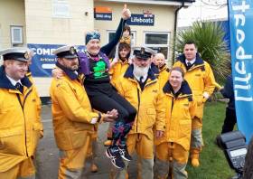 Arklow RNLI crew help Mary Nolan Hickey take a load off after she crossed the finish line yesterday