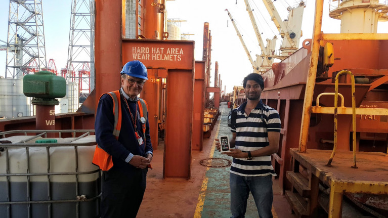 Covid19 Impact: The charity Liverpool Seafarers Centre CEO John Wilson presented an i-phone to stranded Indian seafarer, Nishanth Sadaram who had lost touch with his family after his mobile phone was damaged by seawater. The presentation took place on board the bulk-carrier M.V. Seamec Gallant where the seafarer is the 3rd officer of the 20,969grt bulk-carrier which AFLOAT adds having departed Liverpool is currently at anchorage off Moelfre on the Isle of Anglesey, north Wales.
