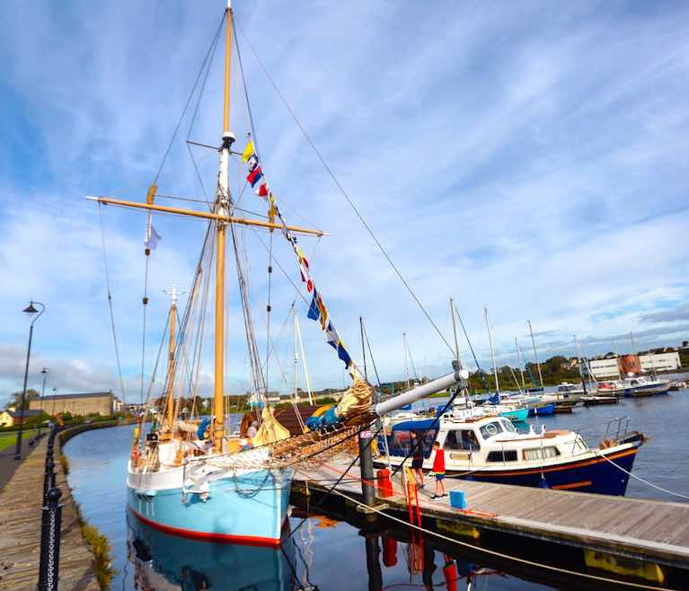 The trading ketch Ilen berthed in County Clare where traditional sail traders berthed before her, at the quayside in Kilrush