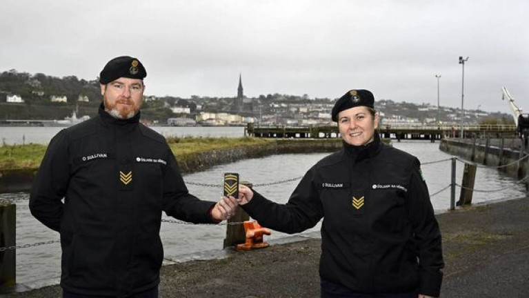 Chief petty officer Patricia O'Sullivan with her new rank markings, alongside fellow petty officer, and brother, Donal O'Sullivan. Afloat adds the photo was taken at the Naval Service Basin in lower Cork Harbour with in the background an Offshore Patrol Vessel (OPV) berthed at Cobh. 