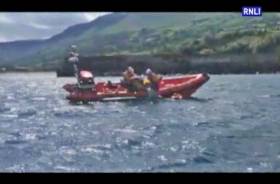 Red Bay RNLI&#039;s volunteer crew recover the stranded kayakers onto the inshore lifeboat