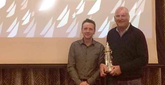 Mark Mansfield (right) collects the boat of the year trophy from ICRA Commodore Simon  McGibney