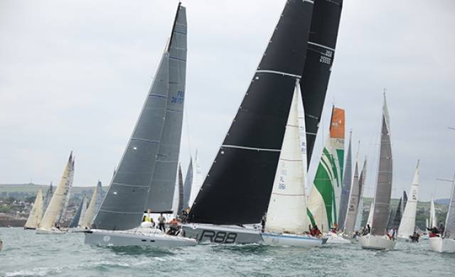 Round Ireland Race start 2016. Rambler 88 (black sails) attempts to get clear air seconds after the start but is surrounded by smaller competitors