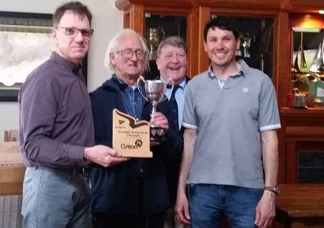 Jeff Condell and Jeff Cochrane of Fuggles accepting the Squib Trophy from Kinsale Yacht Club Commodore Dave Sullivan and Bruce Matthews