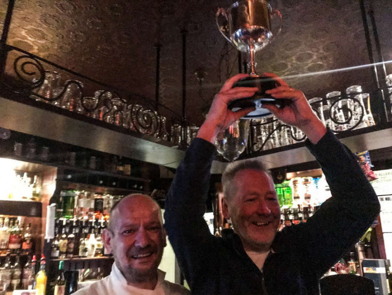 Tony ‘Kiwi’ Spillane holds aloft the winner’s trophy