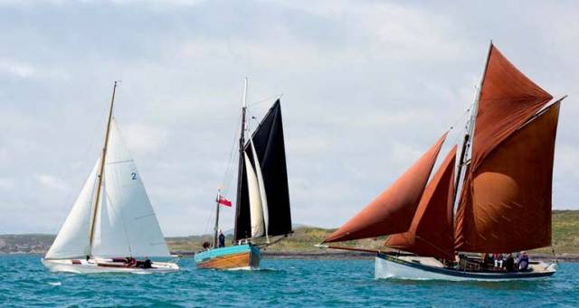 It’s early summer in West Cork, and time for the Baltimore Wooden Boat Festival’s eclectic collection of timber craft to show their style. Typical of the mix are (left to right) Kevin O’Farrell’s Scottish Islands Class Mylne-designed McGruer-built sloop Canna, the Falmouth-based Dandy type Lively (James Baker), and the Mackerel Boat An Run (Nigel Towse, sailed by Ian Wright)