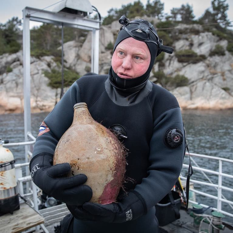 A diver with a bottle from the Irish Sailing Ship 'Providentz' that sank in Norway in 1720
