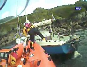 A Union Hall lifeboat volunteer boards the wayward yacht to establish a tow