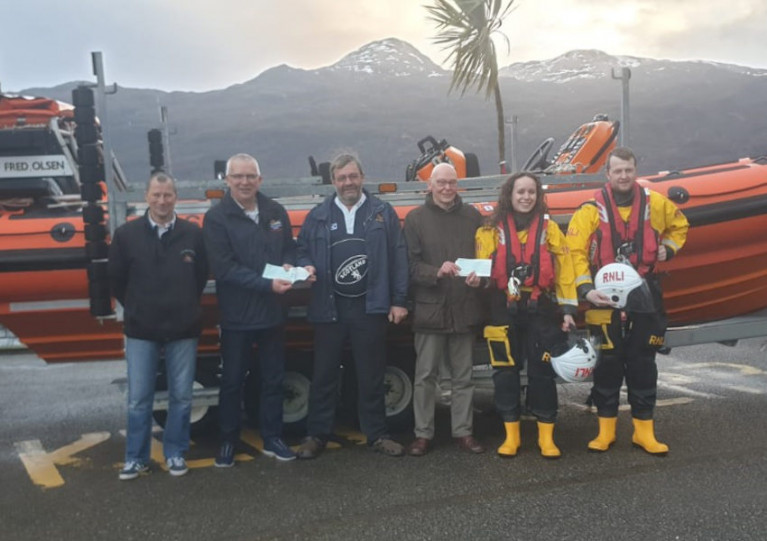 Portree and Kyle of Lochalsh volunteers receive their cheques in front of Kyle’s inshore Atlantic 85, Spirit of Fred Olsen