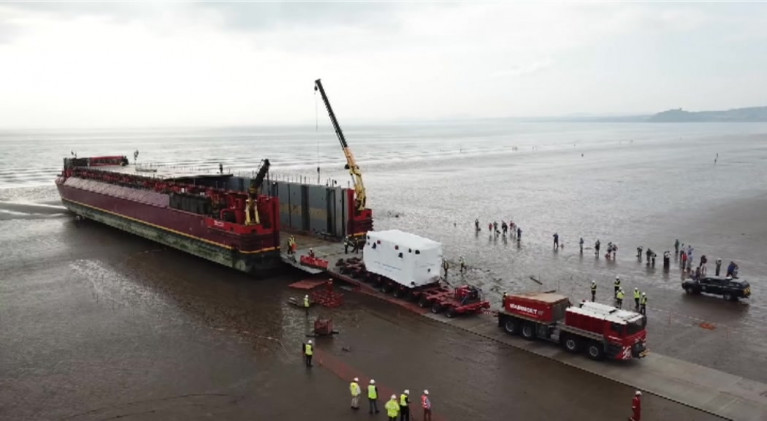 Takes some shifting.... as Afloat adds the transformer attracted crowds on a beach in north Wales from where it is to reach its final destination at Trawsfynyd tomorrow. In the distance is the  Llŷn Peninsula which juts into the Irish Sea south of Anglesey. 