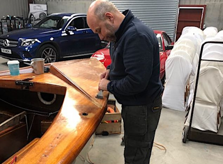 Nigel McNeely working on the restoration of the GP14 dinghy