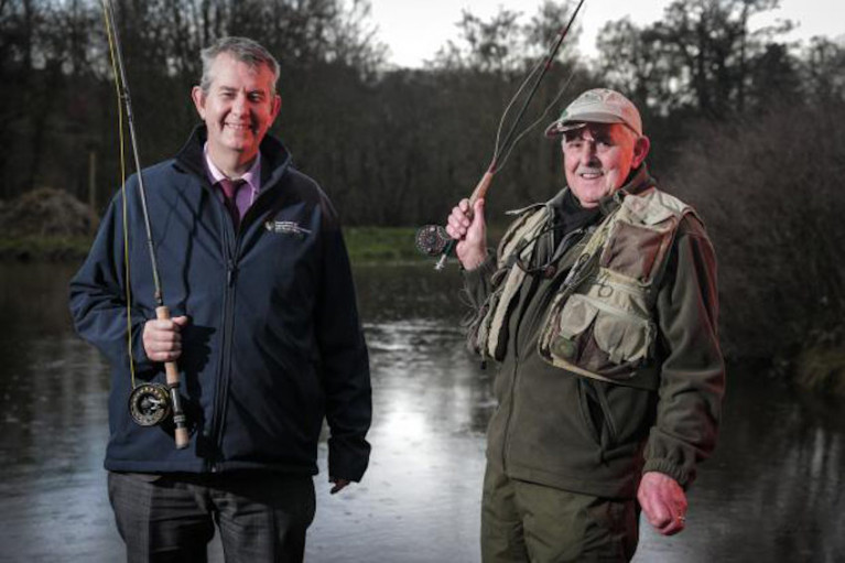 DAERA Minister Edwin Poots pictured with angler Joe Stitt at Shaws Bridge in Belfast to launch the 2020 angling season