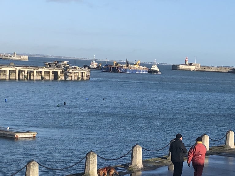 Dun Laoghaire Harbour: A barge laden with Cornish granite is moved by a pair of tugs, AMS Retriever and Vanguard in advance of towage to off the port&#039;s East Pier where operations took place to discharge rock-armour due to damage caused by Storm Emma in 2018. 