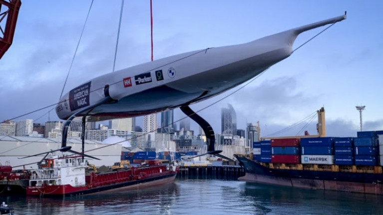 DEFIANT, the first AC75 racing yacht built for New York Yacht Club American Magic is lowered into Auckland harbour