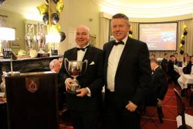 Chris Power-Smith (left) and Flag Officer Frank O&#039;Beirne with last year’s Commodore’s Cup awarded for his and the crew of Aurelia’s performance offshore in 2016