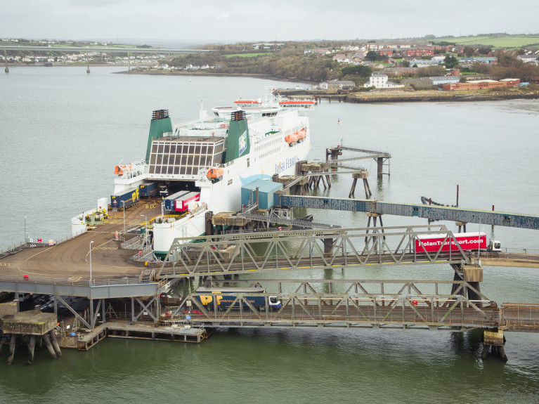 While lorries entering UK from Ireland will not face checks until July of next year, the same checks will be introduced from January 1 on traffic travelling from UK into Ireland. Above AFLOAT adds un-accompanied truck-trailers towed during disembarkation at the south Wales ferry port of Pembroke in Milford Haven. Note the two-tier linkspan serving Irish Ferries 122 freight unit capacity cruiseferry Isle of Inishmore operating on the Rosslare route. 